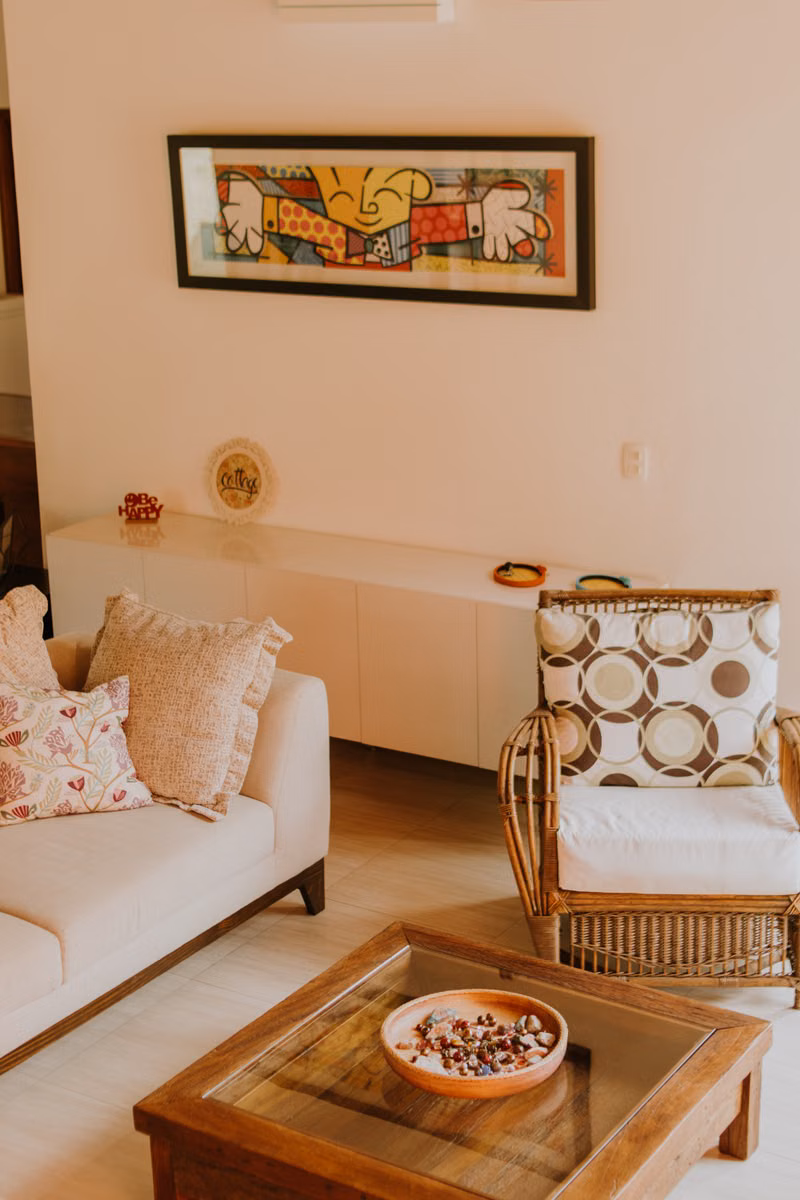 A warm living room styled with rattan and modern art